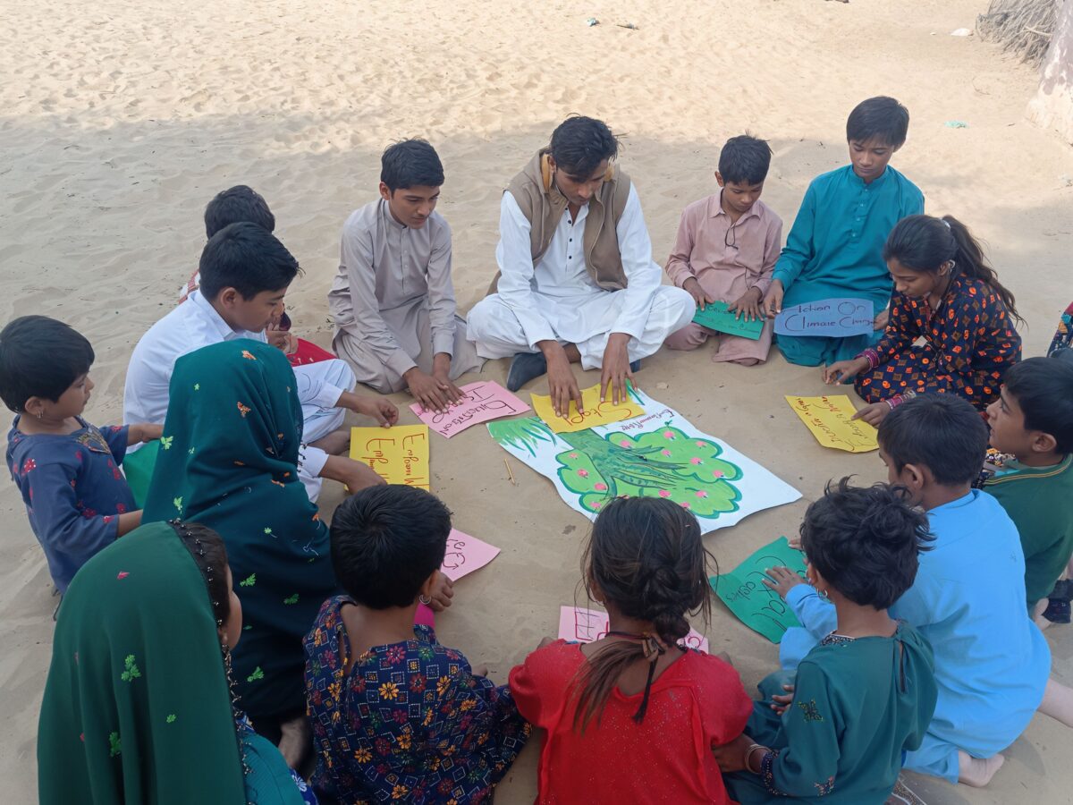 Kamal ul din teaching children in his village abut sustainability. 